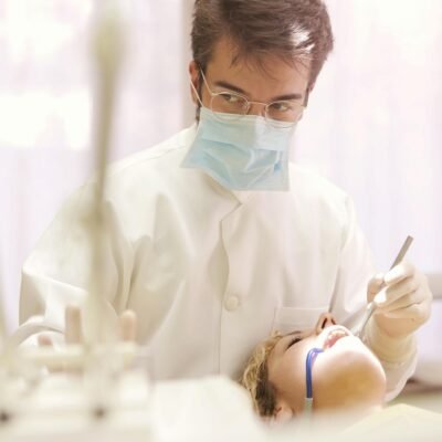 Man in White Button Up Shirt Holding Dental Tool