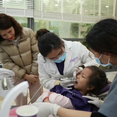 Women and Dentist over Child