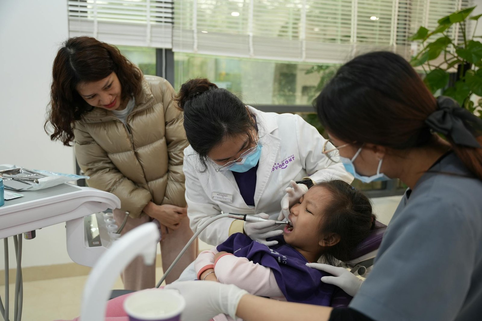 Women and Dentist over Child